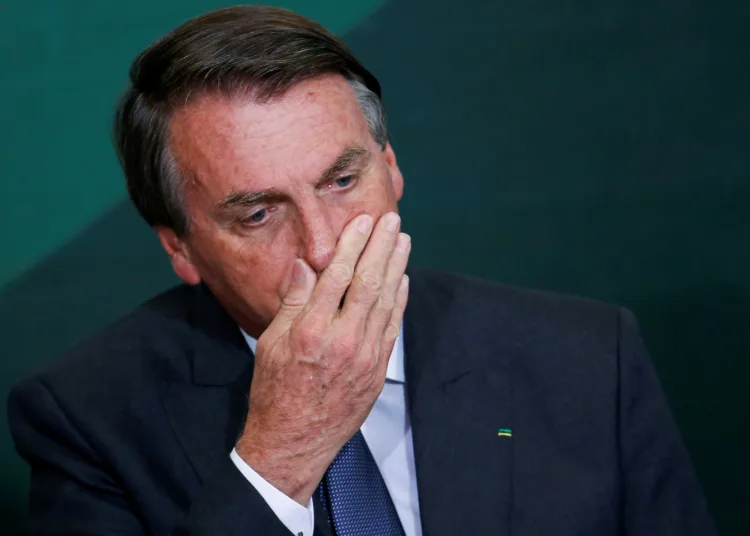 FILE PHOTO: Brazil's President Jair Bolsonaro reacts during the launching ceremony of the National Green Growth Program, at the Planalto Palace in Brasilia, Brazil October 25, 2021. REUTERS/Adriano Machado/File Photo