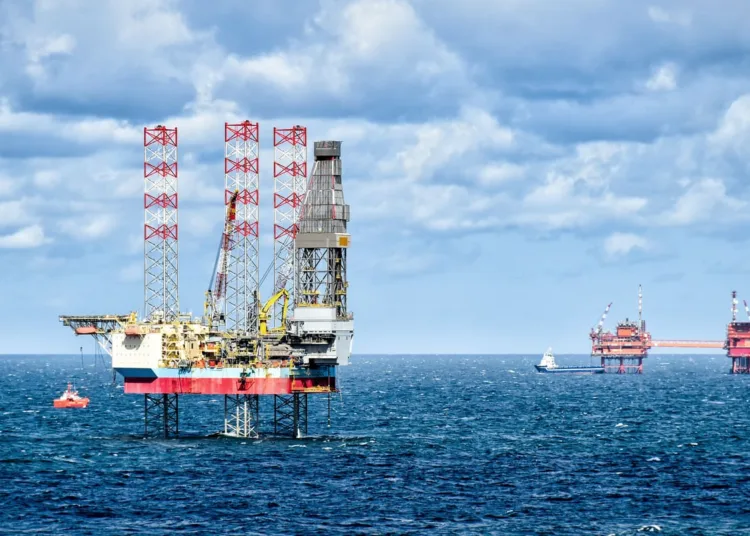 Oil rigs and supply vessels at sea