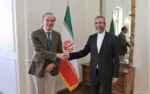 In this photo released by the Iranian Foreign Ministry, Enrique Mora, a leading European Union diplomat, left, shakes hands with Iran's top nuclear negotiator Ali Bagheri Kani in Tehran, Iran, Sunday, March 27, 2022. Mora held talks in Tehran amid hopes that an agreement to restore Iran's tattered nuclear deal with world powers could be completed. (Iranian Foreign Ministry via AP)