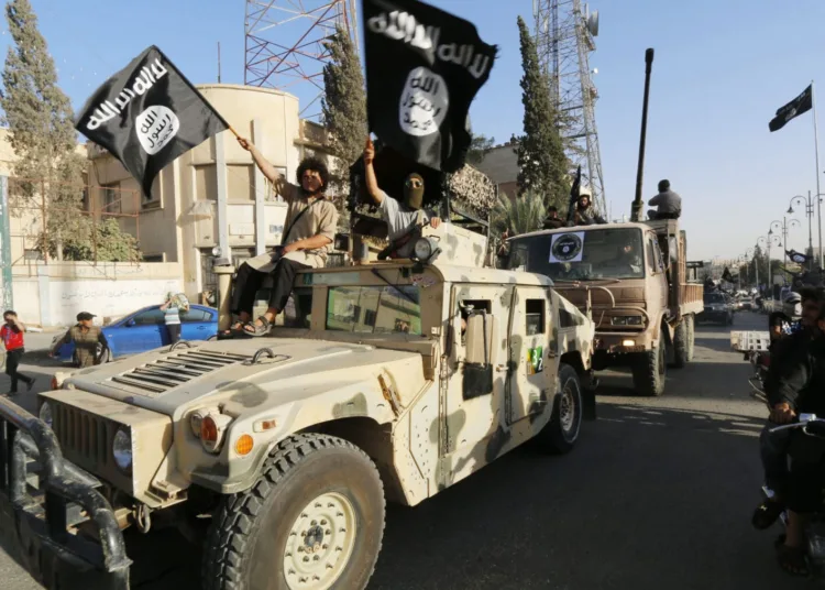 Militant Islamist fighters take part in a military parade along the streets of Syria's northern Raqqa province June 30, 2014.
