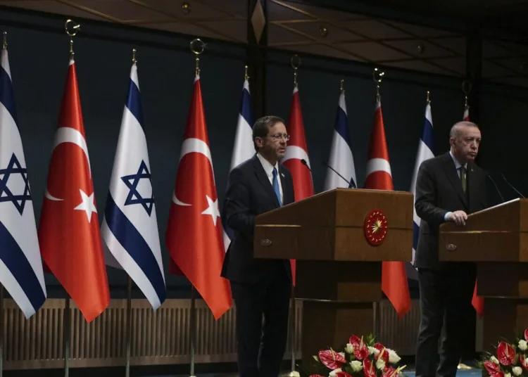 Turkish President Recep Tayyip Erdogan, right, and Israel's President Isaac Herzog speak to the media after their talks, in Ankara, Turkey, Wednesday, March 9, 2022. Israeli President Isaac Herzog arrived in Turkey Wednesday for talks with President Recep Tayyip Erdogan, becoming the first leader from Israel to visit in 14 years as the two countries move to turn a new page in their troubled relationship.(AP Photo/Burhan Ozbilici)