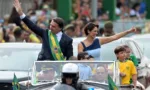 Brazilian President Jair Bolsonaro (L) and First Lady Michelle Bolsonaro wave during a military parade to mark Brazil's 200th anniversary of independence in Brasilia, on September 7, 2022. (Photo by EVARISTO SA / AFP)