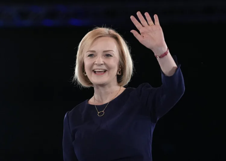 Liz Truss waves on stage after a Conservative leadership election hustings at Wembley Arena in London, Wednesday, Aug. 31, 2022. Britain's Prime Minister Boris Johnson announced his resignation in early July. His Conservative Party is set to announce his successor on Monday. (AP Photo/Kirsty Wigglesworth)