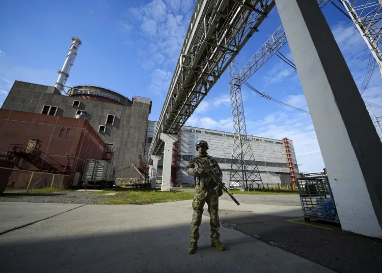 FILE - A Russian serviceman guards an area of the Zaporizhzhia Nuclear Power Station in territory under Russian military control, southeastern Ukraine, May 1, 2022. Ukrainians are once again anxious and alarmed about the fate of a nuclear power plant in a land that was home to the world’s worst atomic accident in 1986 at Chernobyl. The Zaporizhzhia nuclear plant, Europe’s largest, has been occupied by Russian forces and continued fighting nearby has heightened fears of a catastrophe that could affect nearby towns in southern Ukraine or beyond. (AP Photo/File)