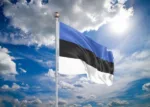 Realistic flag. 3D illustration. Colored waving flag of Estonia on sunny blue sky background.