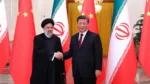 This handout picture provided by the Iranian presidency shows Chinese President Xi Jinping welcoming the Islamic Republic's President Ebrahim Raisi (L) during his visit in Beijing on February 14, 2023. (Photo by Iranian Presidency / AFP) / === RESTRICTED TO EDITORIAL USE - MANDATORY CREDIT "AFP PHOTO / HO / IRANIAN PRESIDENCY" - NO MARKETING NO ADVERTISING CAMPAIGNS - DISTRIBUTED AS A SERVICE TO CLIENTS ===