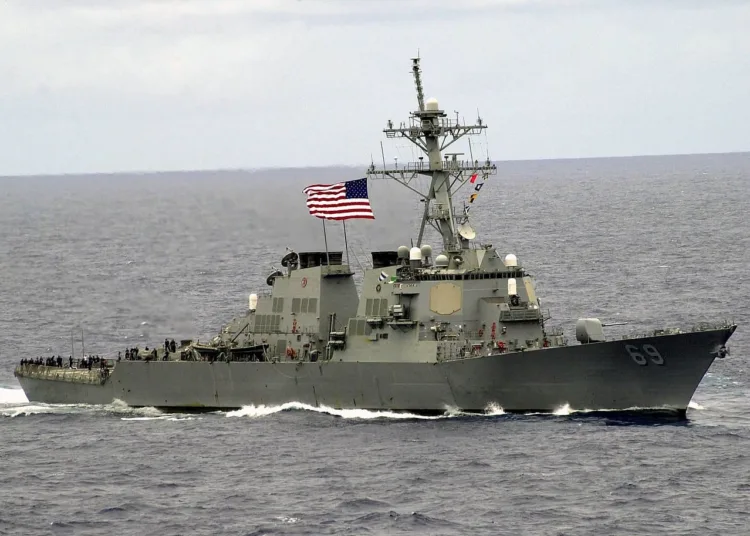 030520-N-0295M-008.ABOARD USS CONSTELLATION (May 20, 2003) Ð During a practice sea power demonstration for Constellation's upcoming Tiger Cruise, the Destroyer Milius (DDG-69) proudly displays it's large American Flag as it sails by Constellation (CV-64). Constellation and its battle group are returning from deployment in which it supported Operations Southern Watch, Enduring Freedom and Iraqi Freedom. U.S. Navy photo by Photographer's Mate 2nd Class Daniel J. McLain                               .