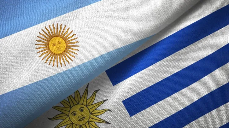 Uruguay and Argentina flags together textile cloth, fabric texture
