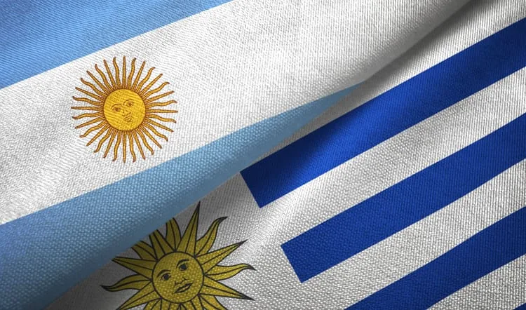 Uruguay and Argentina flags together textile cloth, fabric texture