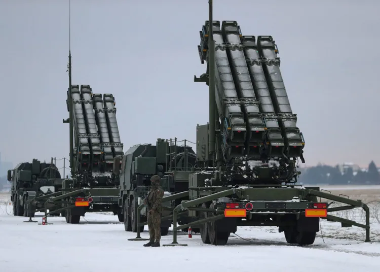 FILE PHOTO: Serviceman patrols in front of the Patriot air defence system during Polish military training on the missile systems at the airport in Warsaw, Poland February 7, 2023. REUTERS/Kacper Pempel