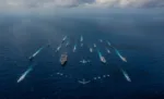 FILE PHOTO: The aircraft carrier USS Ronald Reagan and the Japan Maritime Self-Defense Force helicopter destroyer JS Hyuga sail in formation with 16 other ships from the U.S. Navy and the Japan Maritime Self-Defense Force as aircraft from the U.S. Air Force and Japan Air Self-Defense Force fly overhead in formation during Keen Sword in the Philippine Sea November 8, 2018.   Courtesy Kaila V. Peters/U.S. Navy/Handout via REUTERS/File Photo.  ATTENTION EDITORS - THIS IMAGE HAS BEEN SUPPLIED BY A THIRD PARTY.   To match Special Report TAIWAN-CHINA/SUBMARINES