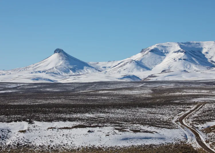 Disaster Peak, left, punctuates the northwest rim of the McDermitt Caldera in southeast Oregon in this Jan. 14, 2022, photo. The historic lakebed in the foreground contains some of the highest concentrations of lithium in the United States.