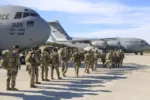 U.S. Army Paratroopers assigned to the 2nd Battalion, 504th Parachute Infantry Regiment, 1st Brigade Combat Team, 82nd Airborne Division, deploy from Pope Army Airfield, N.C., on  Jan. 1, 2020.