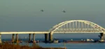 This video grab taken from footage of local media Kerch Info on November 25, 2018 shows Russian aircraft flying over the Crimean Bridge that spans the Kerch Strait, a narrow strip that links the Azov and Black seas, as a Russian ship blocks the strait, after Russia fired on and then seized three Ukrainian ships on November 25, accusing them of illegally entering its waters in the Sea of Azov. - Kiev and Moscow were facing their worst crisis in years on November 26 as Ukraine and its Western allies demanded the release of three ships fired on and seized by Russia near Crimea. Ukraine's military was on high alert and parliament was meeting to vote on a request to impose martial law from President Poroshenko who accused Moscow of a "new phase of aggression." (Photo by KERCH INFO / AFP) / RESTRICTED TO EDITORIAL USE - MANDATORY CREDIT "AFP PHOTO / KERCH INFO" - NO MARKETING NO ADVERTISING CAMPAIGNS - DISTRIBUTED AS A SERVICE TO CLIENTS