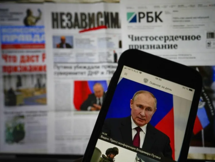 The app of the Russian government newspaper is displayed on an iPhone screen showing Russian President Vladimir Putin during his speech in the Kremlin in Moscow, Russia, Tuesday, Feb. 22, 2022. As the West sounds the alarm about the Kremlin ordering troops into eastern Ukraine and decries an invasion, Russian state media paints a completely different picture. It portrays the move as Moscow coming to the rescue of war-torn areas tormented by Ukraine’s aggression and bringing them much-needed peace. (AP Photo/Alexander Zemlianichenko Jr)