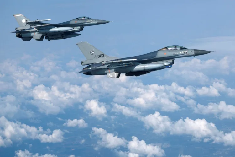 FILE PHOTO: Netherlands' Air Force F-16 fighter jets fly during a media day illustrating how NATO Air Policing safeguards the Allies' airspace in the northern and northeastern region of the Alliance, July 4, 2023. REUTERS/Piroschka van de Wouw/File Photo