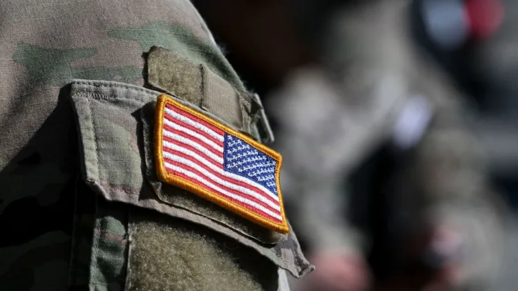 A US flag is pictured on a soldier's uniform at the United States Army military training base in Grafenwoehr, southern Germany, on March 11, 2022. (Photo by Christof STACHE / AFP) (Photo by CHRISTOF STACHE/AFP via Getty Images)