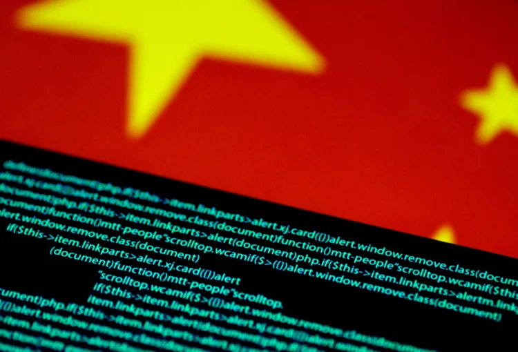 FILE PHOTO: Computer code is seen on a screen above a Chinese flag in this July 12, 2017 illustration photo. REUTERS/Thomas White/Illustration