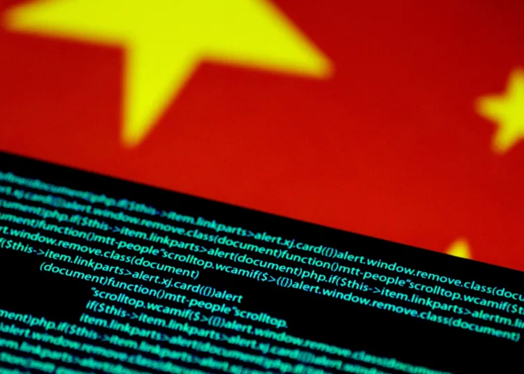 FILE PHOTO: Computer code is seen on a screen above a Chinese flag in this July 12, 2017 illustration photo. REUTERS/Thomas White/Illustration