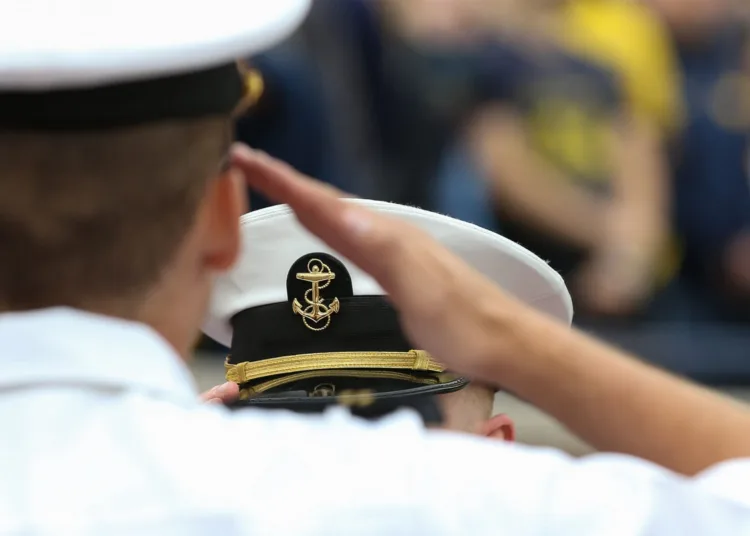 ANN ARBOR, MI - SEPTEMBER 08:  A U.S. Navy officer salutes during the playing of the national anthem prior to the start of the game between Western Michigan and Michigan (21) on September 8, 2018 at Michigan Stadium in Ann Arbor, Michigan. (Photo by Scott W. Grau/Icon Sportswire via Getty Images)
