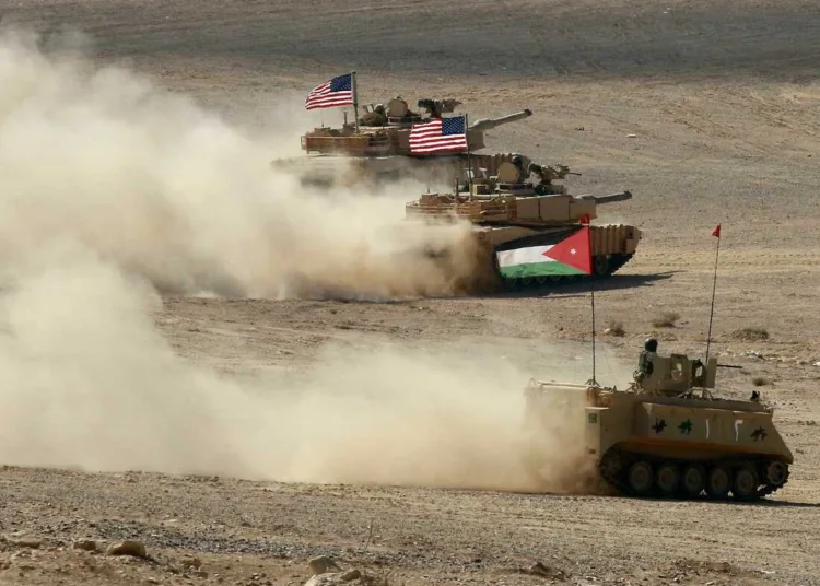 A Jordanian APC and US tanks take part in the "Eager Lion" multinational military manuever, in the Al-Zarqa governorate, some 85km northeast of the Jordanian capital Amman, on September 14, 2022. - The United States, Jordan, and 28 partner nations are taking part in the multinational military exercise, from September 4 to 15, 2022, representing one of the largest military exercises in the region, and designed to exchange military expertise and improve interoperability among partner nations. (Photo by Khalil MAZRAAWI / AFP) (Photo by KHALIL MAZRAAWI/AFP via Getty Images)