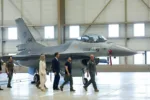 Ukrainian President Volodymyr Zelenskiy and Dutch Prime Minister Mark Rutte walk near an F-16, in Eindhoven, Netherlands, August 20, 2023. REUTERS/Piroschka van de Wouw