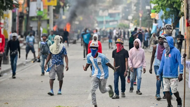 People demonstrate calling for the departure of Haitian Prime Minister Ariel Henry in Port-au-Prince on February 7, 2024. (Photo by Richard PIERRIN / AFP)
