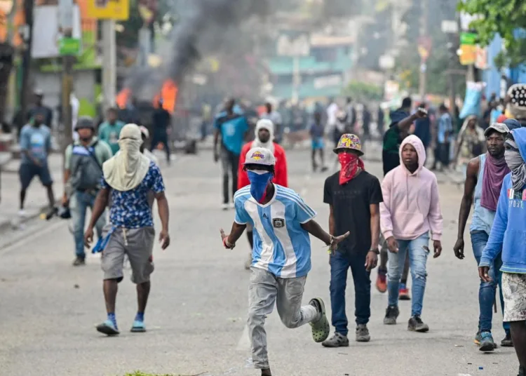 People demonstrate calling for the departure of Haitian Prime Minister Ariel Henry in Port-au-Prince on February 7, 2024. (Photo by Richard PIERRIN / AFP)