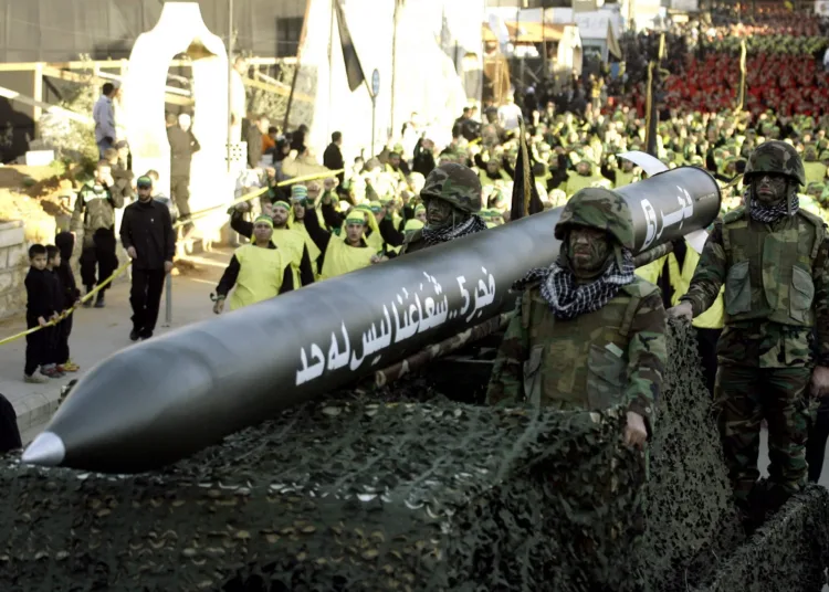 Lebanese Shiite Muslim Hezbollah militants ride on a vehicle carrying a Fajr 5 missile during the annual parade in the southern town of Nabatiyeh on November 28, 2012, to mark the 13th day of Muharram on the Islamic calendar, commemorating and mourning the seventh-century martyrdom of Prophet Muhammad's grandson, Imam Hussein, in the battle of Karbala in Iraq. AFP PHOTO/MAHMOUD ZAYYAT (Photo credit should read MAHMOUD ZAYYAT/AFP/Getty Images)