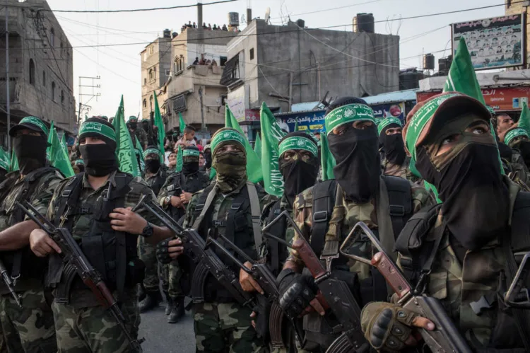 GAZA CITY, GAZA - JULY 20:  Palestinian Hamas militants are seen during a military show in the Bani Suheila district on July 20, 2017 in Gaza City, Gaza. For the past ten years Gaza residents have lived with constant power shortages, in recent years these cuts have worsened, with supply of regular power limited to four hours a day. On June 11, 2017 Israel announced a new round of cuts at the request of the Palestinian authorities and the decision was seen as an attempt by President Mahmoud Abbas to pressure Gaza's Hamas leadership. Prior to the new cuts Gaza received 150 megawatts per day, far below it's requirements of 450 megawatts. In April, Gaza's sole power station which supplied 60 megawatts shut down, after running out of fuel, the three lines from Egypt, which provided 27 megawatts are rarely operational, leaving Gaza reliant on the 125 megawatts supplied by Israel's power plant. The new cuts now restrict electricity to three hours a day severely effecting hospital patients with chronic conditions and babies on life support. During blackout hours residents use private generators, solar panels and battery operated light sources to live. June 2017 also marked ten years since Israel began a land, sea and air blockade over Gaza. Under the blockade, movement of people and goods is restricted and exports and imports of raw materials have been banned. The restrictions have virtually cut off access for Gaza's two million residents to the outside world and unemployment rates have skyrocketed forcing many people into poverty and leaving approximately 80% of the population dependent on humanitarian aid.  (Photo by Chris McGrath/Getty Images)