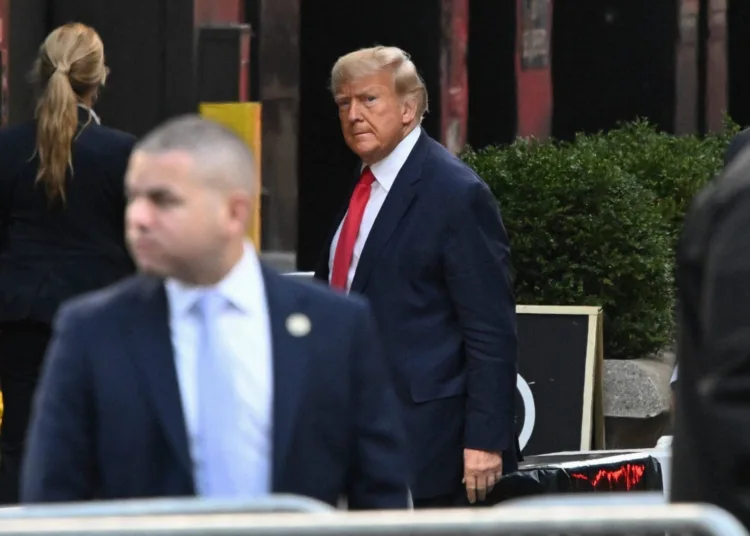 TOPSHOT - Former US President Donald Trump arrives at Trump Tower in New York on April 3, 2023. - Trump arrived on April 3, 2023 in New York where he will surrender to unprecedented criminal charges, taking America into uncharted and potentially volatile territory as he seeks to regain the presidency. The 76-year-old Republican, the first US president ever to be criminally indicted, will be formally charged Tuesday over hush money paid to a porn star during the 2016 election campaign. (Photo by Ed JONES / AFP)