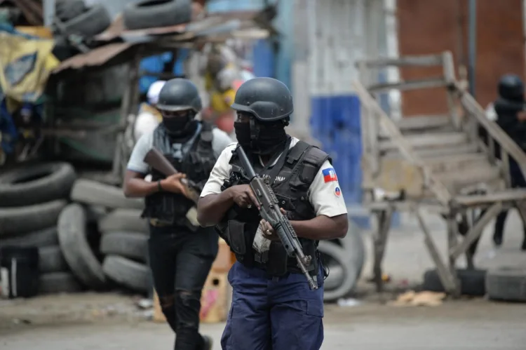 Police officers patrol a neighborhood amid gang-related violence in downtown Port-au-Prince on April 25, 2023. Between April 14 and 19, clashes between rival gangs left nearly 70 people dead, including 18 women and at least two children, according to a United Nations statement released April 24. (Photo by RICHARD PIERRIN / AFP)