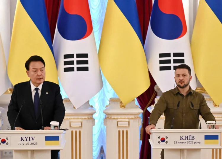 Ukrainian President Volodymyr Zelensky (R) and his South Korean counterpart Yoon Suk Yeol make statements following their talks in Kyiv on July 15, 2023. (Photo by Sergei SUPINSKY / AFP)