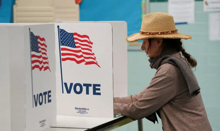 A voter casts her ballot at a polling station on Election Day in Falls Church, Virginia, U.S., November 7, 2023. REUTERS/Kevin Lamarque/ File photo
