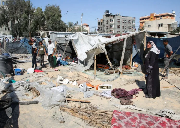 Palestinians inspect the damage following an Israeli strike at a tent camp in Al-Mawasi area, amid Israel-Hamas conflict, in Khan Younis in the southern Gaza Strip July 13, 2024. REUTERS/Hatem Khaled