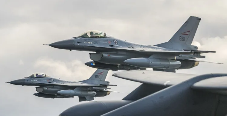 Royal Norwegian Air Force F-16 Fighting Falcons assigned to the 331st Squadron, Bodø Air Force Base, Norway,  fly next to the wing of a U.S. Air Force 2nd Bomb Wing B-52H Stratofortress during training and integration with the Norwegian Air Force in support of Bomber Task Force Europe 20-1, Oct. 30, 2019, in Norwegian airspace. This deployment allows aircrews and support personnel to conduct theater integration and to improve bomber interoperability with joint partners and allied nations. (U.S. Air Force photo by Tech. Sgt. Christopher Ruano)