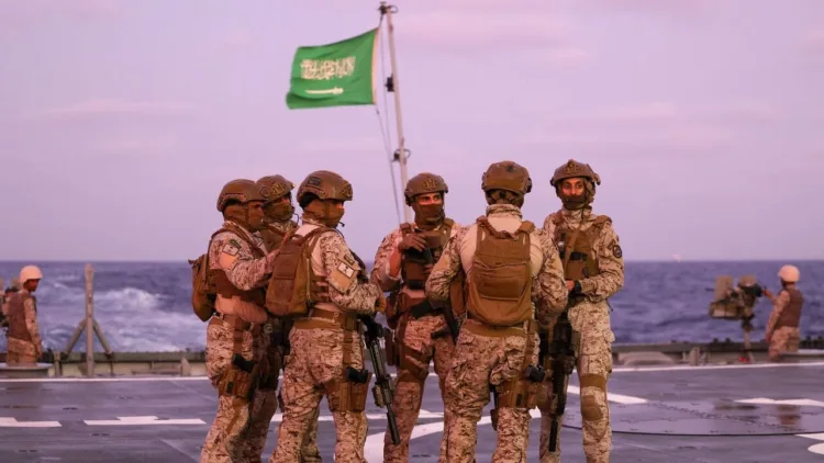 Saudi security officers stand guard onboard a Saudi vessel docked off the seaport of Port Sudan on April 30, 2023, during evacuations efforts from Sudan. - Heavy fighting again rocked Sudan's capital as tens of thousands have fled the bloody turmoil and a former prime minister warned of the "nightmare" risk of a descent into full-scale civil war. Foreign nations have scrambled to evacuate thousands of their citizens by air, road and sea since the fighting plunged the poverty-stricken country into deadly turmoil on April 15. (Photo by Fayez Nureldine / AFP) (Photo by FAYEZ NURELDINE/AFP via Getty Images)