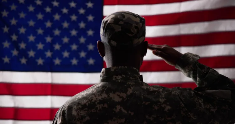 Rear View Of Military Man Saluting Us Flag