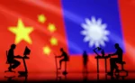 Small figurines with computers are seen in front of Chinese and Taiwanese flags in this illustration, August 6, 2022. REUTERS/Dado Ruvic/Illustration/ File Photo