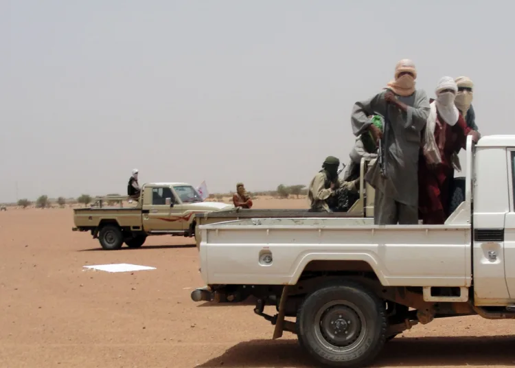 Photo taken on August 7, 2012 shows figthers of the Islamic group Ansar Dine standing in pick-up trucks in Kidal, northern Mali. Mali's government said on August 9 that military intervention in the Islamist-held north was 'inevitable' as the jihadists defied mediation efforts. AFP PHOTO / ROMARIC OLLO HIEN        (Photo credit should read Romaric Hien/AFP/GettyImages)