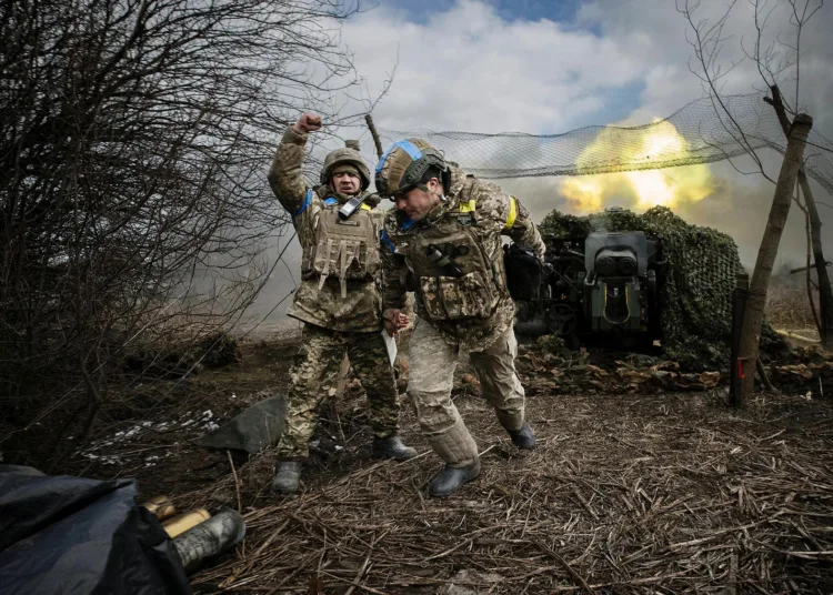 Ukrainian soldiers with the 31st Separate Mechanized Brigade fire a 122-millimeter howitzer D-30 at a Russian target in the Donetsk region of eastern Ukraine, Feb. 20, 2024. Western sanctions haven’t worked and weapons from allies are running low. Pressure may build on Kyiv to seek a settlement, even from a weakened position. (Tyler Hicks/The New York Times)