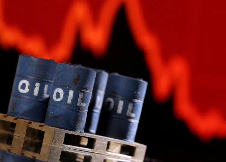 A model of 3D printed oil barrels is seen in front of displayed stock graph going down in this illustration taken, December 1, 2021. REUTERS/Dado Ruvic/Illustration
