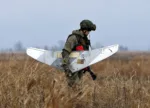 A Russian soldier holds a drone during the joint Russian, Belarusian and Serbian military exercise "The Slavic Brotherhood 2016", at military airport Kovin, 40 kilometers east of Belgrade, Serbia, Monday, Nov. 7, 2016. The 13-day armed exercise in Serbia, dubbed "The Slavic Brotherhood 2016" include 150 Russian paratroopers, 50 air force staffers, 3 transport planes and an unspecified number of troops from Serbia and Belarus, Russia's Defense Ministry said. (AP Photo/Darko Vojinovic)