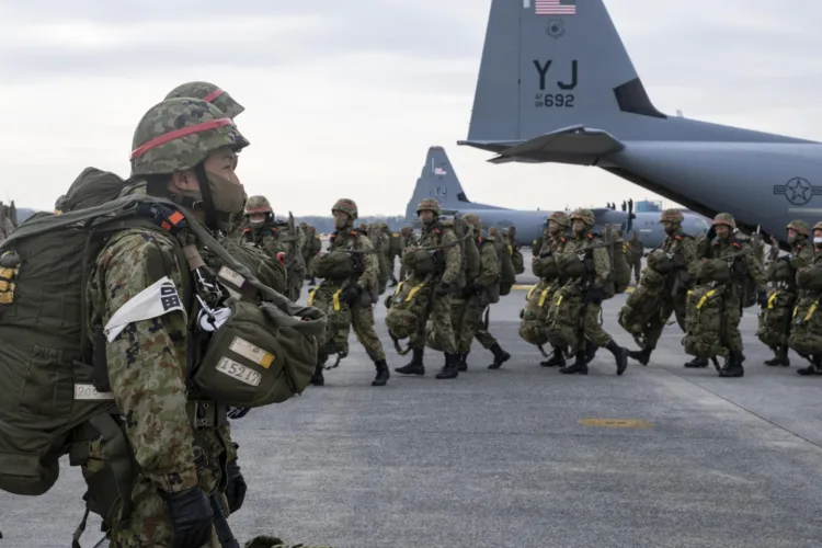 Japan Ground Self Defense Force paratroopers line up to load onto a C-130J Super Hercules, assigned to the 374th Airlift Wing, during exercise Airborne 21 at Yokota Air Base, Japan, March 9, 2021. More than 500 JGSDF paratroopers performed a static-line jump at the Combined Arms Training Center Drop Zone Camp Fuji, Japan, making it the largest U.S-Japan personnel drop in the history of the two countries’ alliance. (U.S. Air Force photo by Staff Sgt. Gabrielle Spalding)