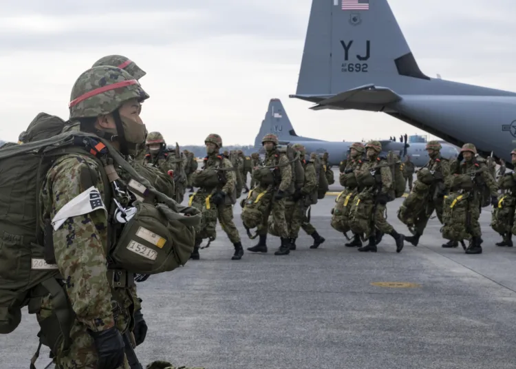 Japan Ground Self Defense Force paratroopers line up to load onto a C-130J Super Hercules, assigned to the 374th Airlift Wing, during exercise Airborne 21 at Yokota Air Base, Japan, March 9, 2021. More than 500 JGSDF paratroopers performed a static-line jump at the Combined Arms Training Center Drop Zone Camp Fuji, Japan, making it the largest U.S-Japan personnel drop in the history of the two countries’ alliance. (U.S. Air Force photo by Staff Sgt. Gabrielle Spalding)
