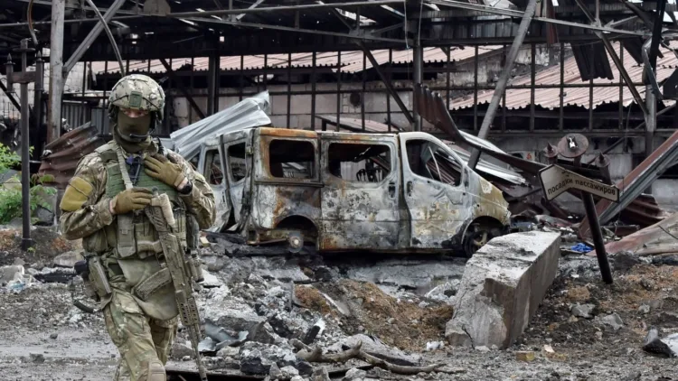A Russian serviceman patrols the destroyed part of the Ilyich Iron and Steel Works in Ukraine's port city of Mariupol on May 18, 2022, amid the ongoing Russian military action in Ukraine. (Photo by Olga MALTSEVA / AFP) (Photo by OLGA MALTSEVA/AFP via Getty Images)