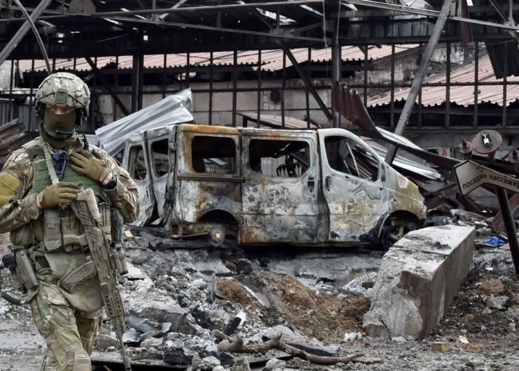 A Russian serviceman patrols the destroyed part of the Ilyich Iron and Steel Works in Ukraine's port city of Mariupol on May 18, 2022, amid the ongoing Russian military action in Ukraine. (Photo by Olga MALTSEVA / AFP) (Photo by OLGA MALTSEVA/AFP via Getty Images)