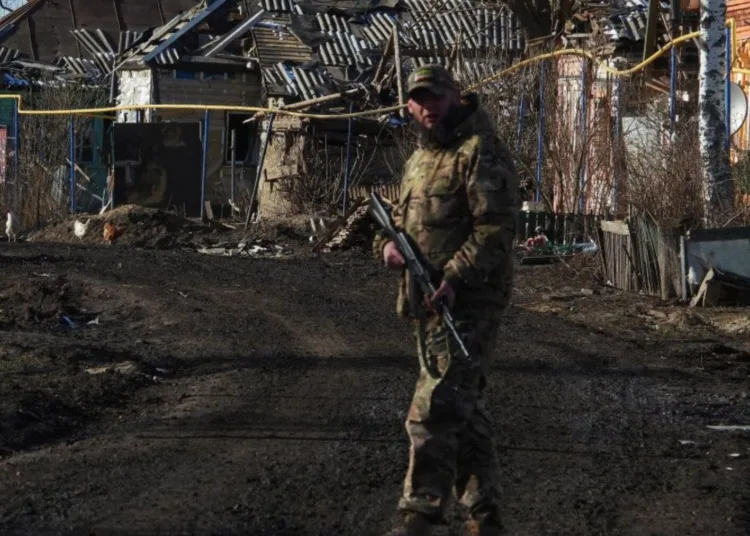 A fighter of the Chechen Akhmat battalion walks past destroyed houses in the village of Kazachya Loknya, in the Sudzha district of the Kursk region on March 18, 2025. (Source: Getty Images