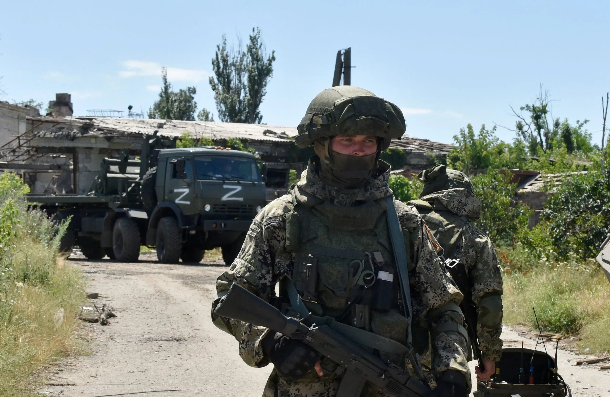 Russian demining team members work to clear an area in the city of Mariupol on July 13, 2022, amid the ongoing Russian military action in Ukraine. (Photo by Olga MALTSEVA / AFP)
