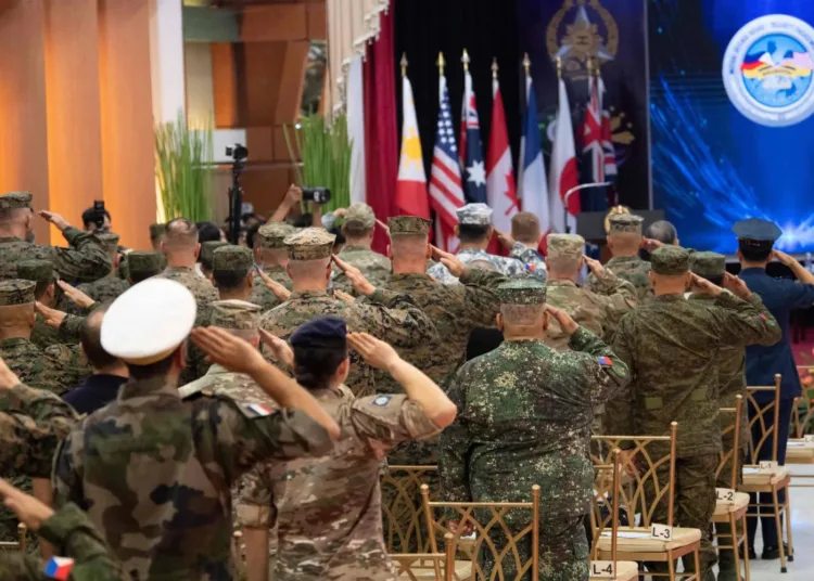 Philippine and US soldiers salute as their national anthems are played during the opening ceremony of the annual Balikatan joint military exercise at Camp Aguinaldo in Quezon city, suburban Manila on April 20, 2026. (AFP)